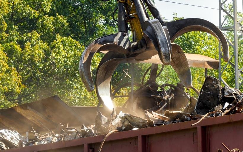 Grapple claw loading scrap metal for a commercial account